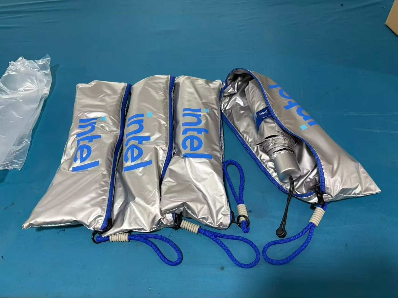 Silver Intel branded folding umbrellas with logo printed sleeves
